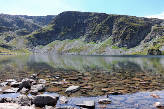 The Kidney (Babreka) Lake view of the water as stones cover the ground seen through the clear lake water at Seven Rila Lakes