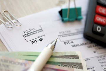 Annual declaration of income tax advances, PIT-4R form on accountant table with pen and polish...