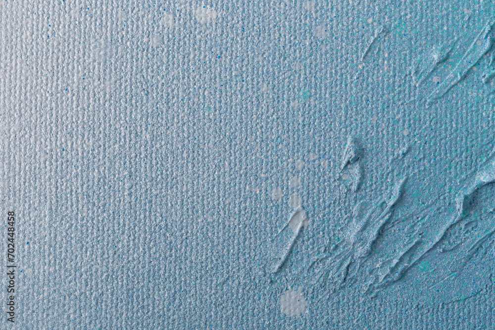 Poster macro close-up of an abstract white, light blue and turquoise spray paint on textured background. hi