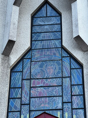 The stained glass window in the front wall of the parish church of Our Lady of Częstochowa in Nieledew showing the Virgin Mary under the influence of the Holy Spirit. – view from the outside. © rparys