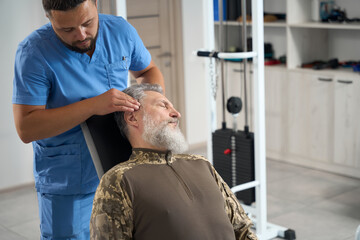 Chiropractor works with a patient in a rehabilitation center