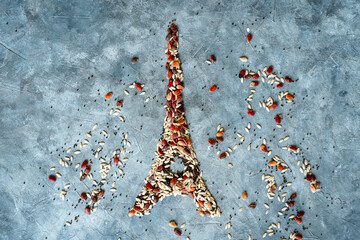 drawing of the Eiffel Tower made up of coloured seeds on a grey background. Cereal-producing...