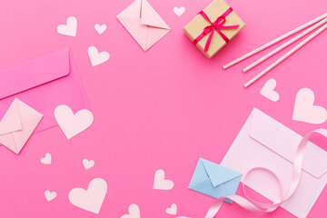 Paper hearts, love letters and gifts on a pink background. Valentine's Day. Love concept. Top view....