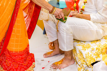 Indian Hindu pre wedding yellow turmeric haldi ceremony feet close up