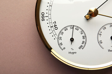 Aneroid barometer on brown background