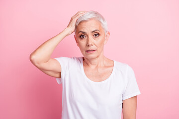 Portrait of astonished serious person dressed stylish t-shirt hold arm on head forget about black...