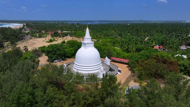 Aerial Panning Shot Of Muhudu Maha Vihara Buddhist Temple By Beach On Sunny Day - Pottuvil, Sri Lanka