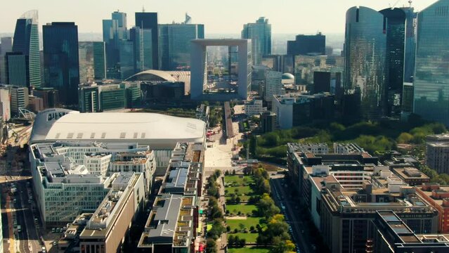 Establishing Aerial view of Business District La Defense in Paris Downtown with Skyscrapers, Office Buildings and Grande Arche. Modern Cityscape of Capital of France. 4K drone tilt down shot