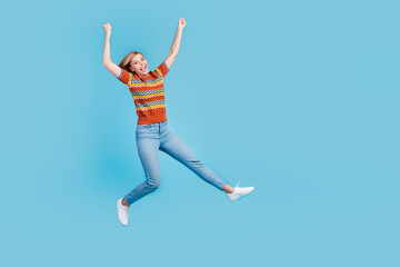 Fototapeta na wymiar Full length photo of optimistic girl wear strited t-shirt jeans flying hands up celebrate balck friday isolated on blue color background