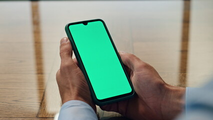 Man hands hold chromakey mobile in office closeup. Unknown ceo checking messages