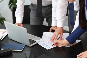 Business consultants working with diagrams in office, closeup