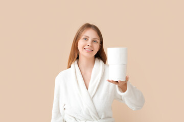 Young woman in bathrobe with toilet paper rolls on color background - obrazy, fototapety, plakaty