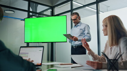 Businessman presenting green screen strategy indoors. Coach teaching managers