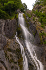 Fototapeta na wymiar Tall waterfall cascading over igneous rock - Aber Falls (Rhaeadr Fawr) North Wales