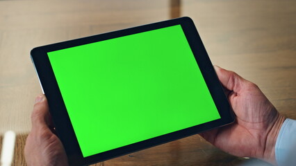 Closeup chromakey tablet man hands hold in office. Ceo using green screen device
