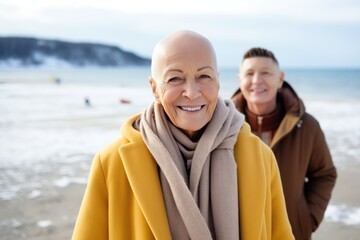 A woman with cancer without hair peacefully meditating on a serene beach near sea