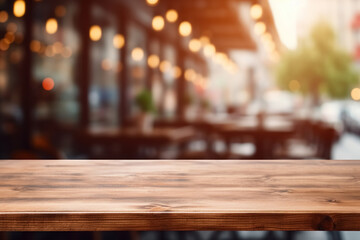 Fototapeta na wymiar Empty wooden table outdoor street cafe decorated with lights, blurred defocused background, copy space