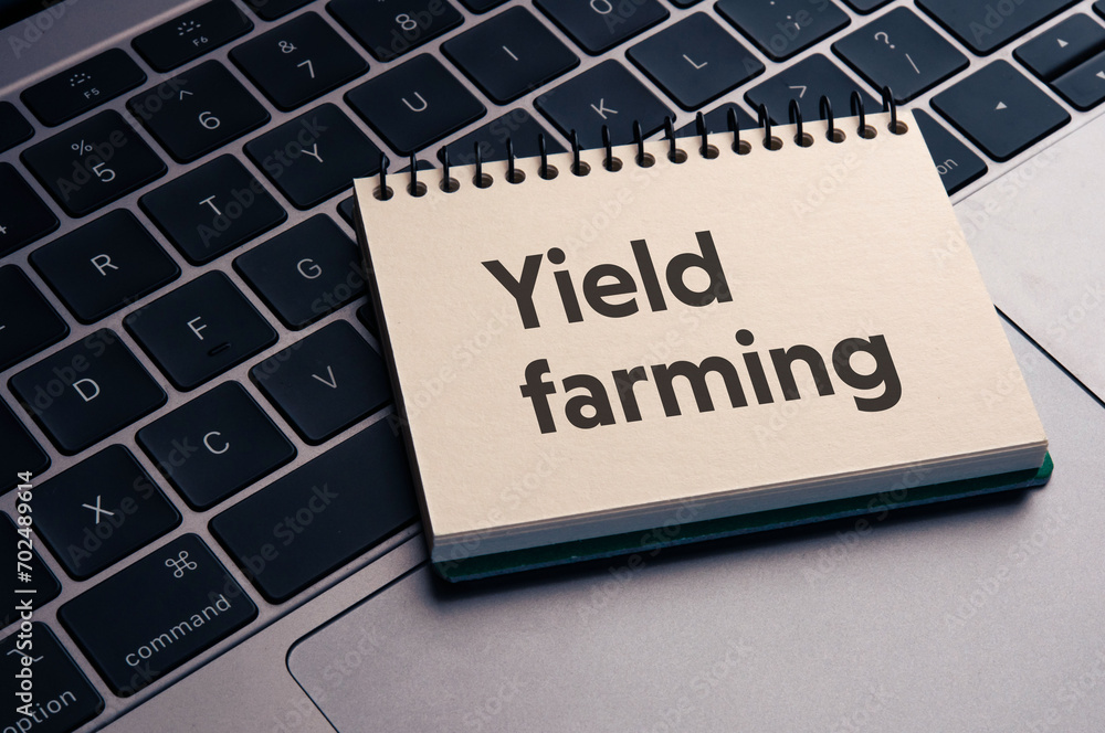 Poster there is notebook with the word yield farming. it is as an eye-catching image.