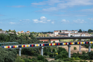 Colorful subway and train line bridge in the background in valley of Olaias, Lisbon PORTUGAL