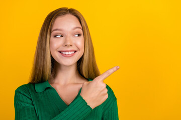 Portrait of cheerful friendly girl beaming smile look indicate finger empty space ad isolated on...