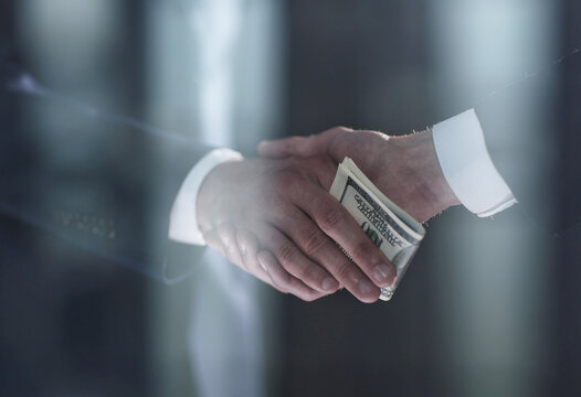 Businessman Hand Giving Money On Black Background