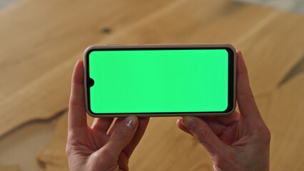 Greenscreen phone lady hands holding office close up. Woman watching telephone