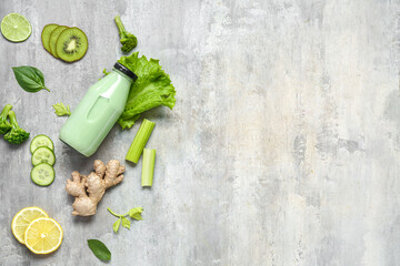 Bottle of tasty juice with fresh vegetables and fruits on grey background