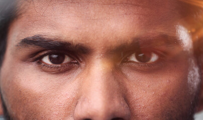Fototapeta premium Close-up of the face and eyes of an Indian man in an emotional pose, eyes open