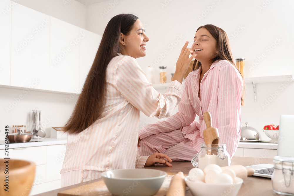 Sticker happy mother with her little daughter cooking in kitchen