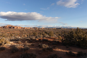 rock formations in the desert with mountains in the backgrounds 