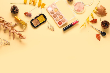 Beautiful autumn composition with different makeup products on beige background
