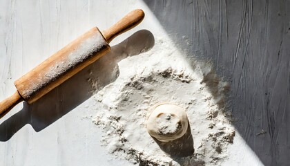 Baking desk with flour and rolling pin, top view.