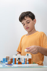 Fototapeta premium 10 year old Brazilian child in pajamas, playing with building blocks_13.