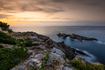 Fototapeta na wymiar Coastal rocks at sunset seascape
