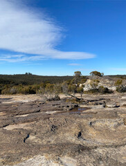Views from a mountain-top lookout. Blue mountains, Australia, NSW. Rock formation and dry vegetation at the summit. Arid desert climate.