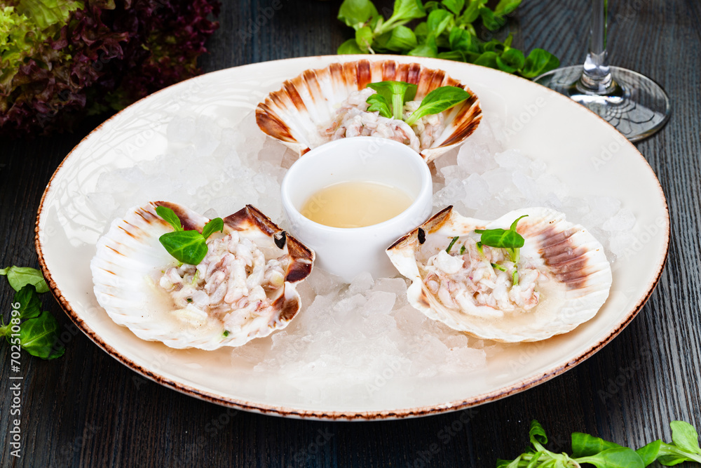 Wall mural Ceviche. Finely chopped raw squid marinated in lemon juice served in seashell.