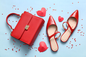 Composition with stylish female shoes, handbag and hearts on color background. Valentine's Day celebration - obrazy, fototapety, plakaty