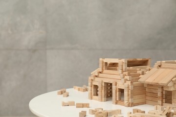 Wooden construction set on white table, space for text. Children's toy