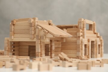 Wooden construction set on white table, closeup. Children's toy