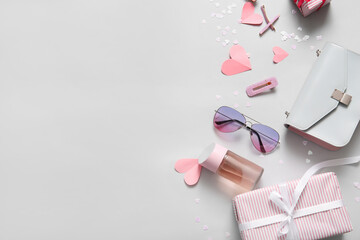 Composition with stylish female accessories, gift box and paper hearts on light background....
