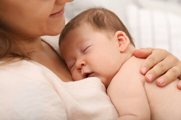 Obraz na płótnie Canvas Mother holding her cute newborn baby indoors