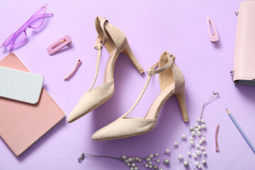 Composition with stylish high heeled shoes, female accessories and mobile phone on lilac background