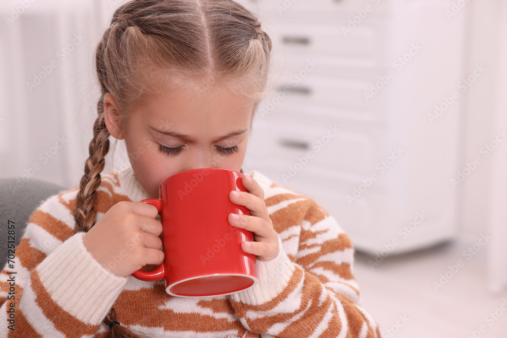 Sticker Cute girl drinking beverage from red ceramic mug at home, space for text