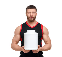 Young man with muscular body holding jar of protein powder on white background