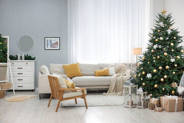 Christmas tree in furnished living room. Festive interior design