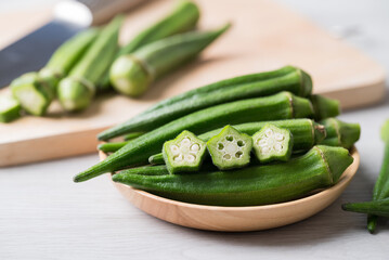 Green okra in wooden bowl prepare for cooking, Organic vegetables