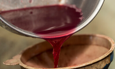 Wine making. Fresh grape juice is poured through a funnel into a barrel. Harvest home. Technology...