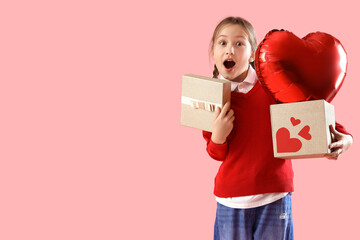 Shocked little girl with gifts and heart-shaped air balloon for Valentine's day on pink background