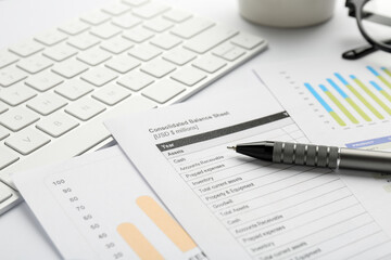 Naklejka na ściany i meble Accounting documents, pen and computer keyboard on white table, closeup