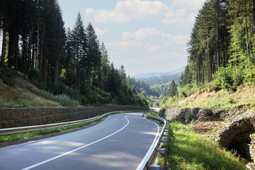 Picturesque view of empty asphalt road near forest